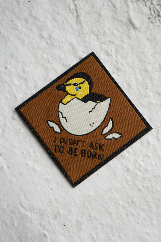 Patch featuring a duckling hatching out of an egg and the phrase "I didn't ask to be born"
