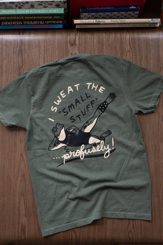 Deep green t-shirt featuring an anxious frog print, seen from the back